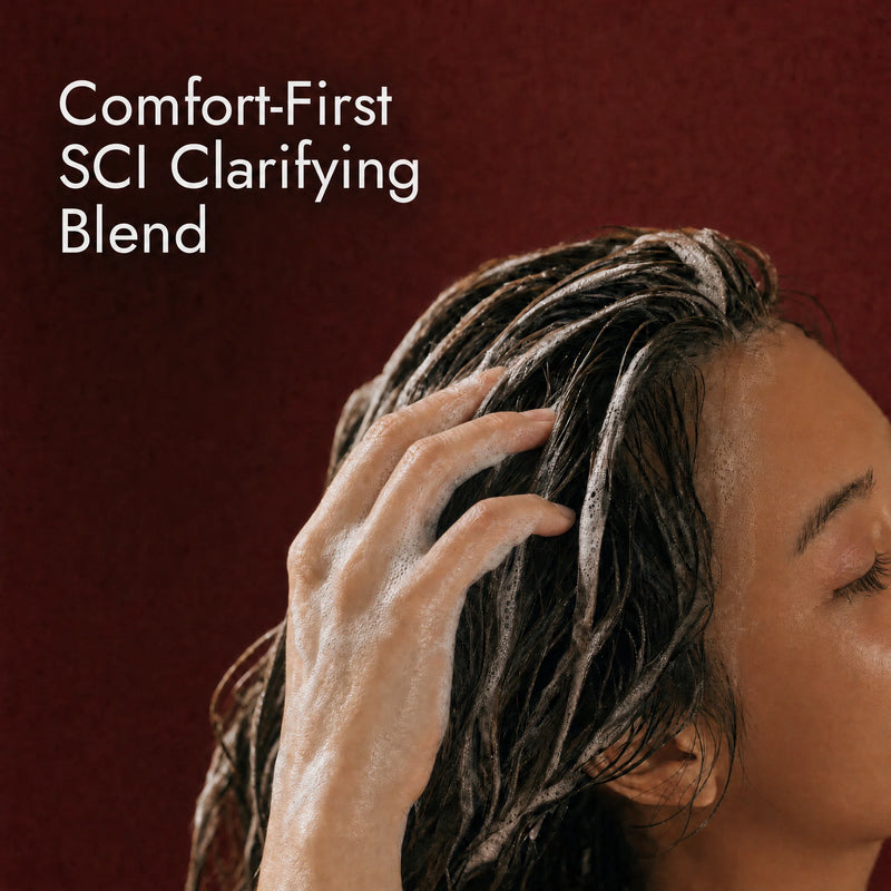Clarifying solid shampoo bar being applied to wet buildup-prone roots